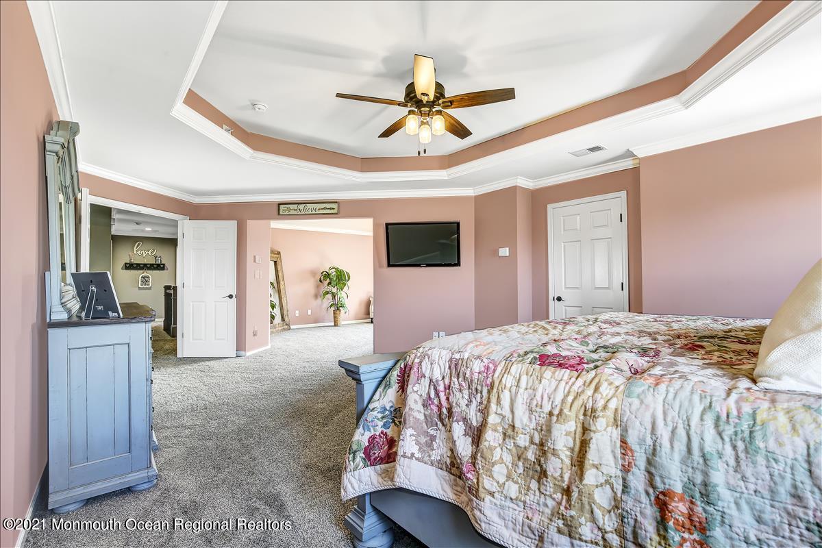 5 Jake Drive Cream Ridge, NJ 08514 - Photo 35 of 64 a bedroom with a bed and a chandelier