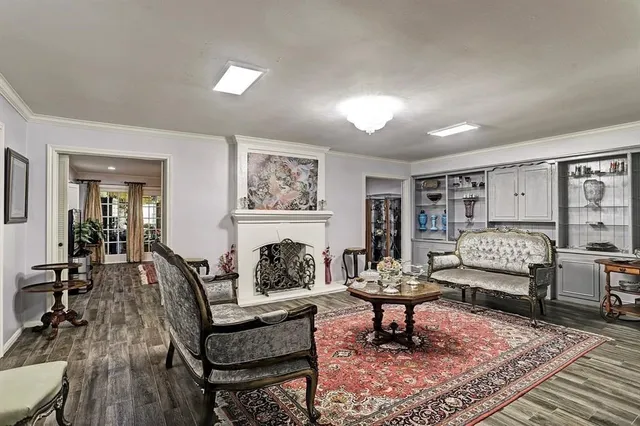 a living room with furniture and a painting on the wall