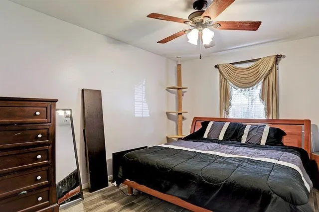 a bedroom with a bed and wooden floor