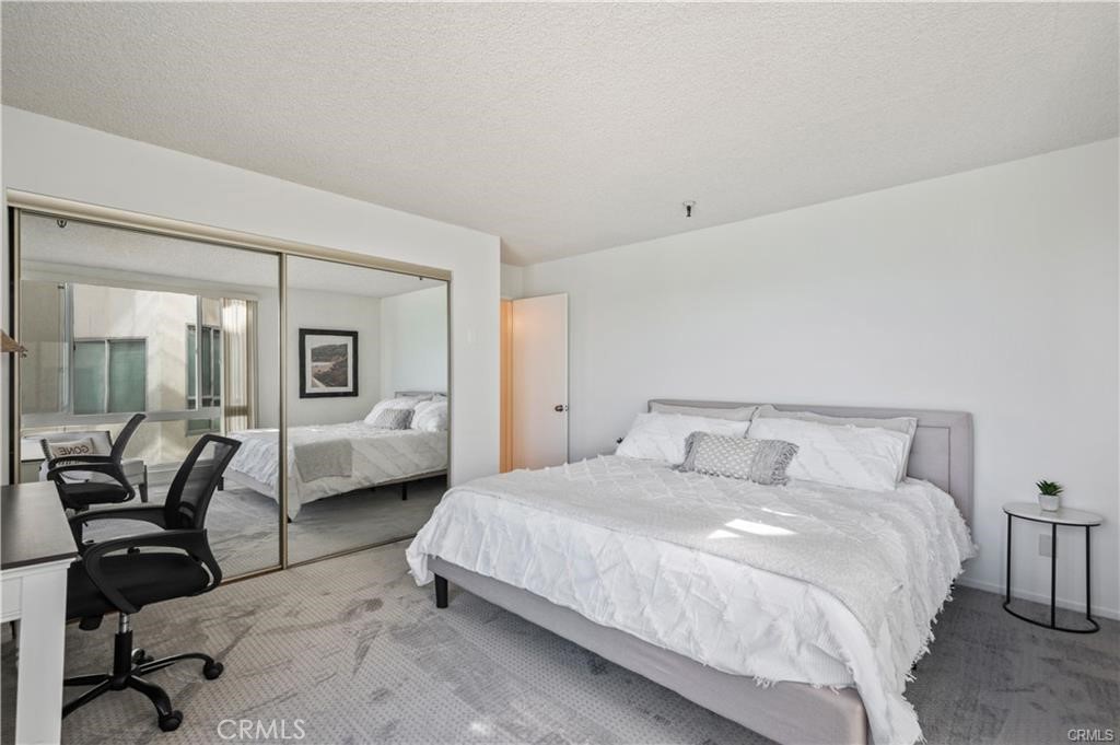 565 Esplanade, Unit 308 Redondo Beach, CA 90277 - Photo 13 of 28 a bedroom with a bed and furniture