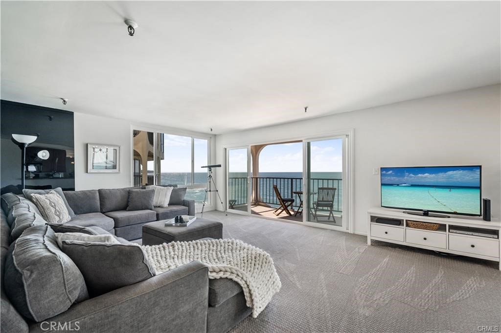 565 Esplanade, Unit 308 Redondo Beach, CA 90277 - Photo 4 of 28 a living room with furniture and a flat screen tv