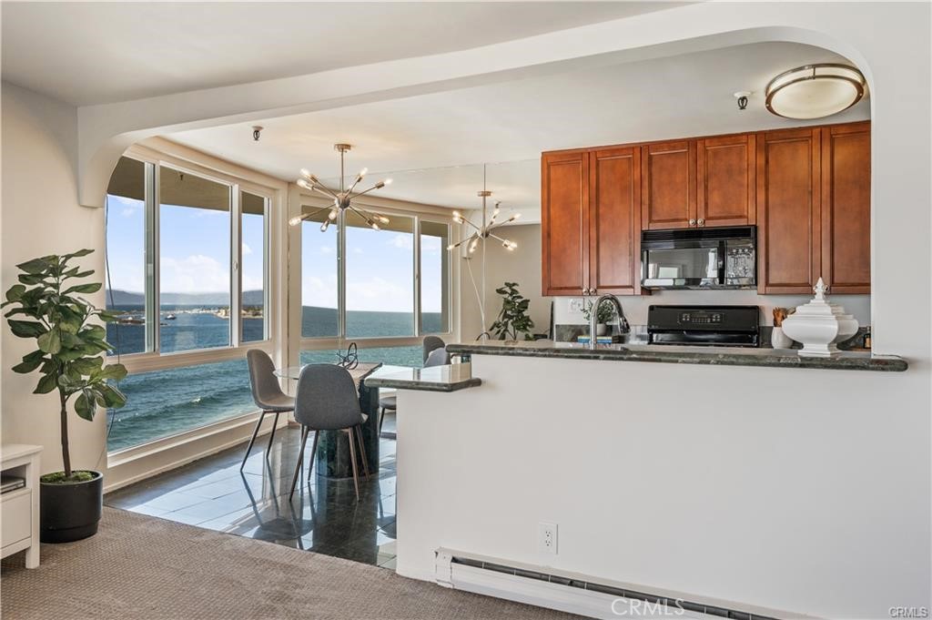 565 Esplanade, Unit 308 Redondo Beach, CA 90277 - Photo 8 of 28 a view of a kitchen with a large window and furniture