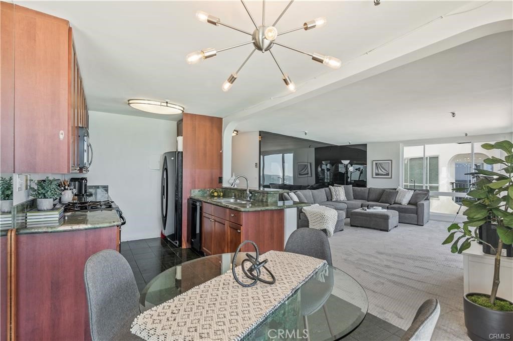 565 Esplanade, Unit 308 Redondo Beach, CA 90277 - Photo 10 of 28 a living room with furniture or chandelier and a wooden floor