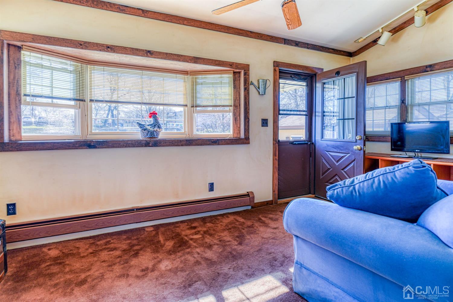 154 East Hill Road Colonia, NJ 07067 - Photo 12 of 25 a living room with furniture cabinets and a window