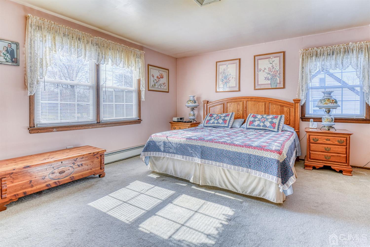 154 East Hill Road Colonia, NJ 07067 - Photo 19 of 25 a bedroom with a bed and a dresser next to a window