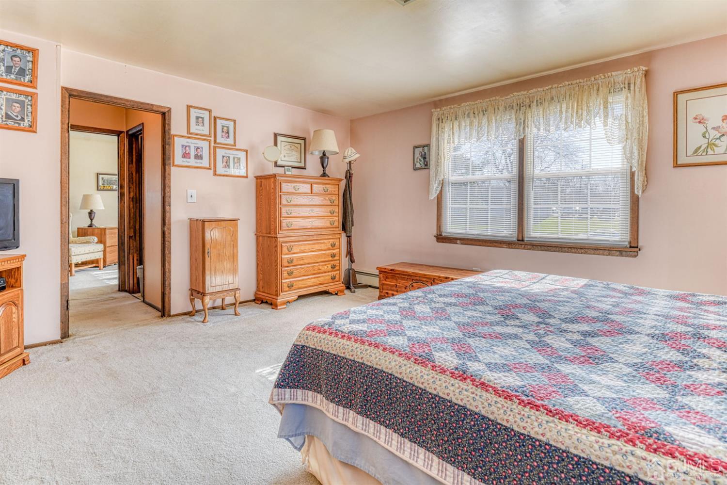 154 East Hill Road Colonia, NJ 07067 - Photo 20 of 25 a spacious bedroom with a bed and a window