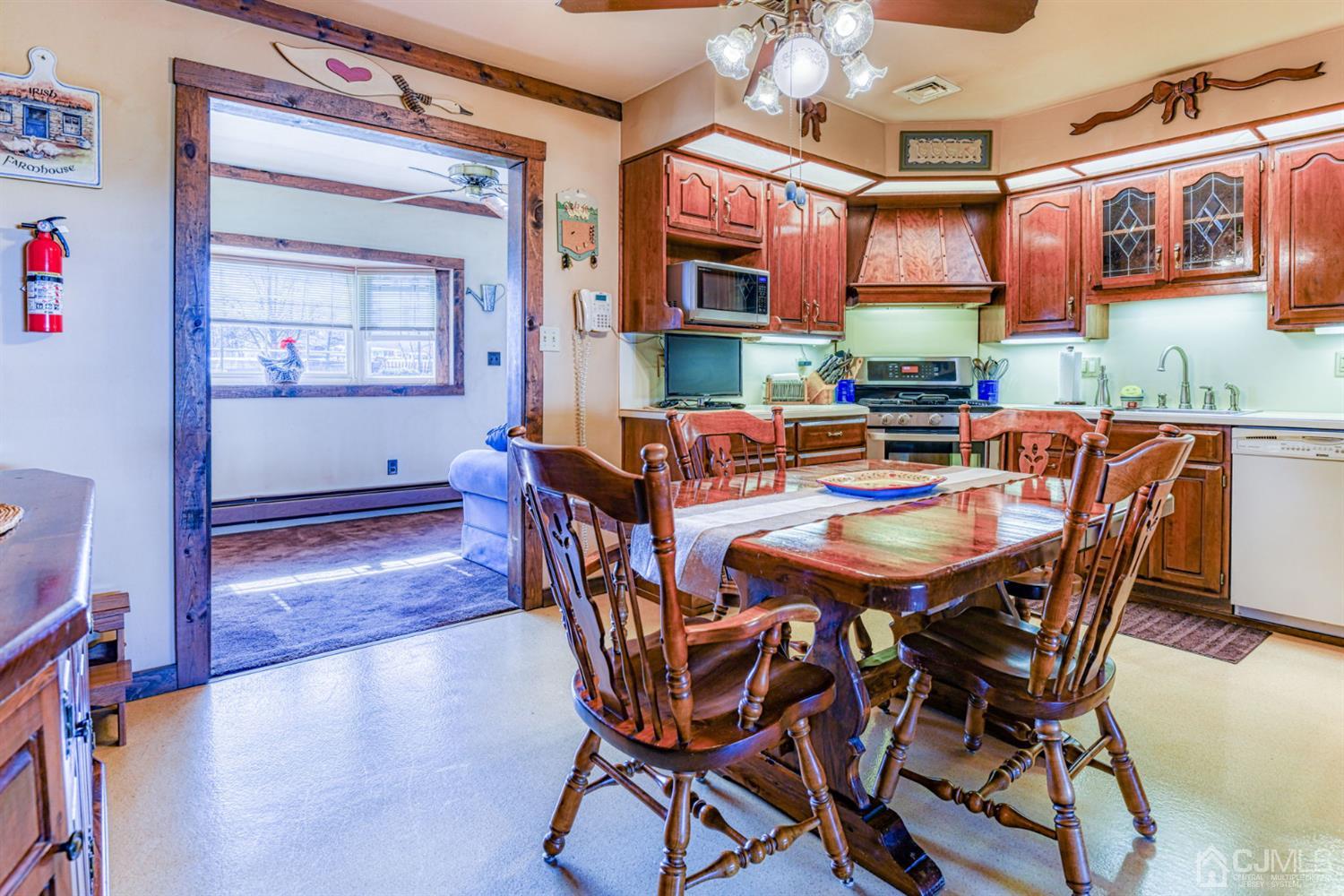 154 East Hill Road Colonia, NJ 07067 - Photo 8 of 25 a dining room with furniture and wooden floor