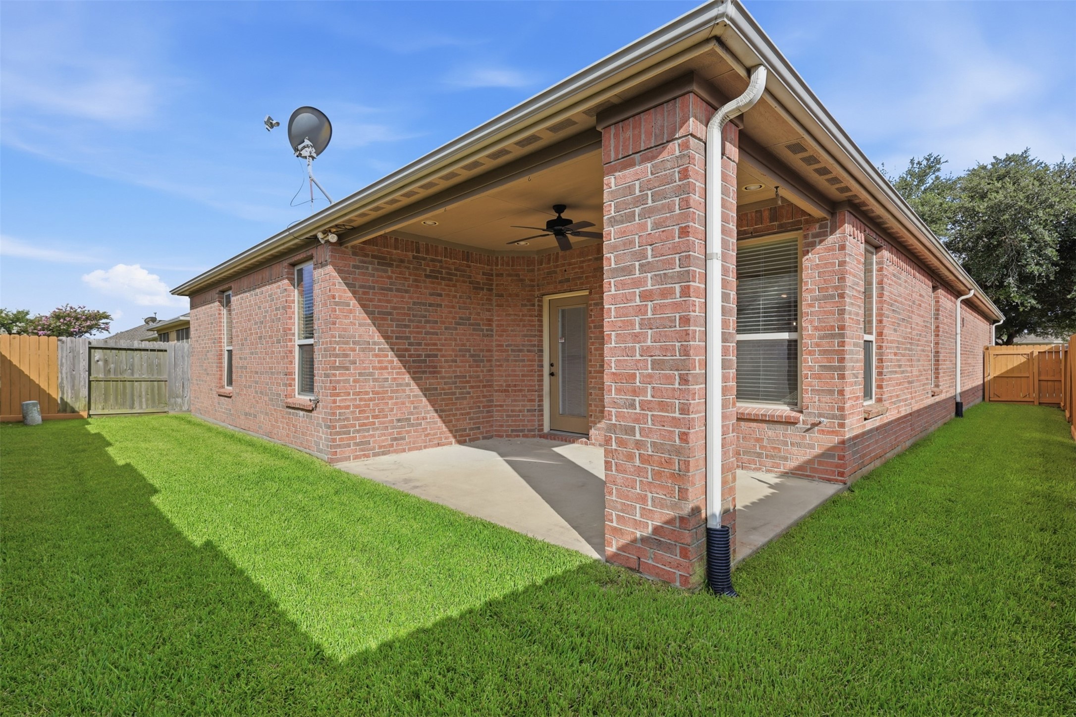 721 Rufina Street League City, TX 77573 - Photo 22 of 33 Step outside to a generously sized covered patio designed for year-round outdoor living. Complete with a ceiling fan and ample space for dining or relaxing, this comfortable retreat overlooks the fully fenced backyard.