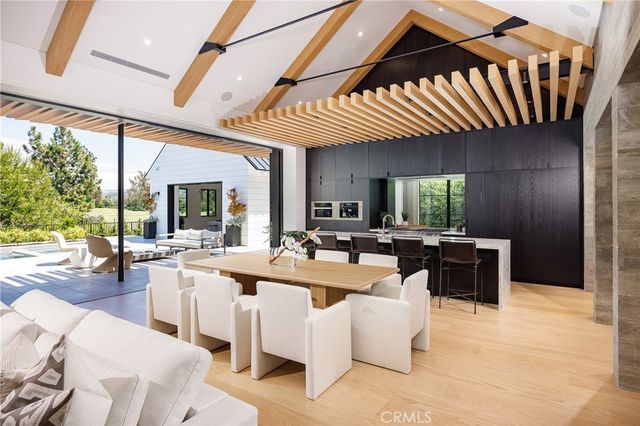a view of a dining room with furniture water and mountain view