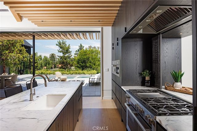 a kitchen with sink and mirror