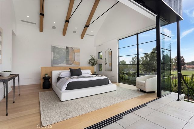 a bed room with a bed and a potted plant