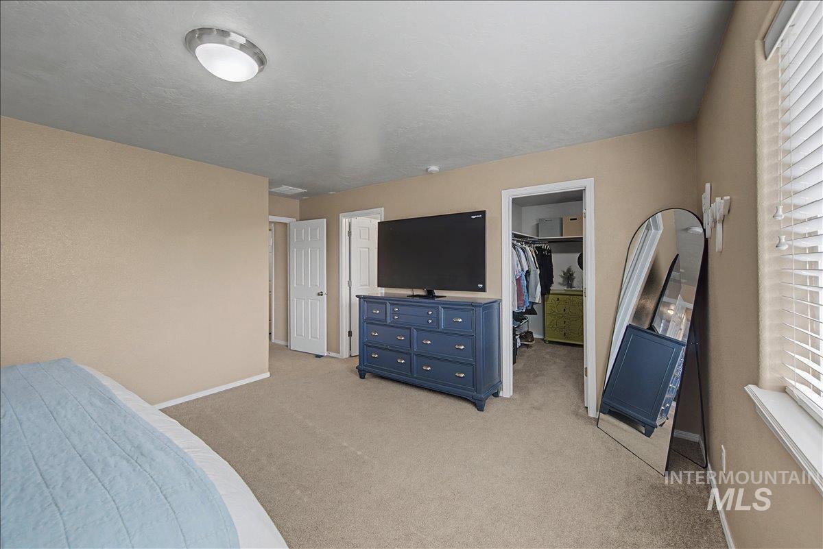 681 West Archerfield Street Meridian, ID 83646 - Photo 22 of 43 Bedroom with a walk in closet and light colored carpet