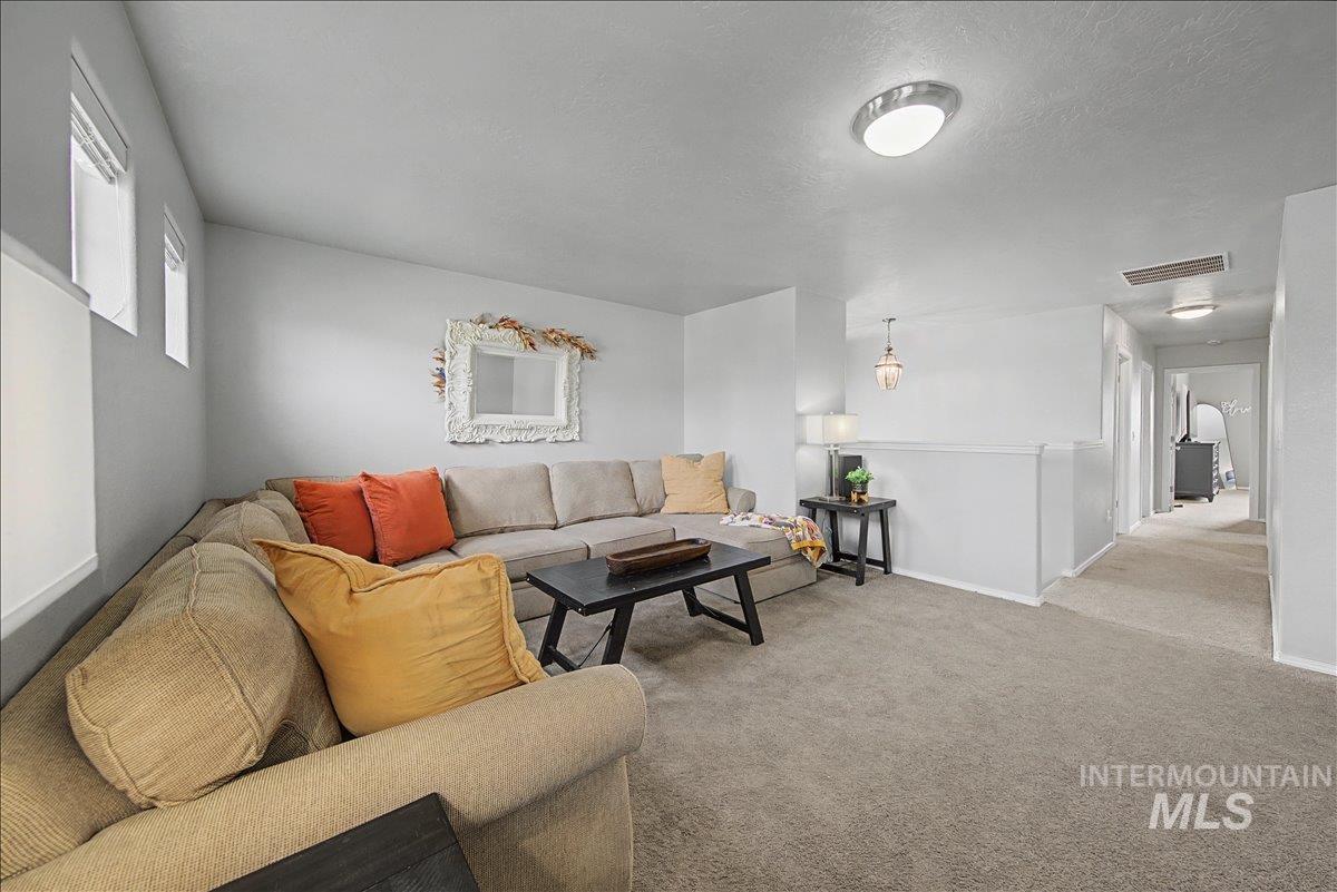 681 West Archerfield Street Meridian, ID 83646 - Photo 29 of 43 Living room featuring carpet floors and a textured ceiling