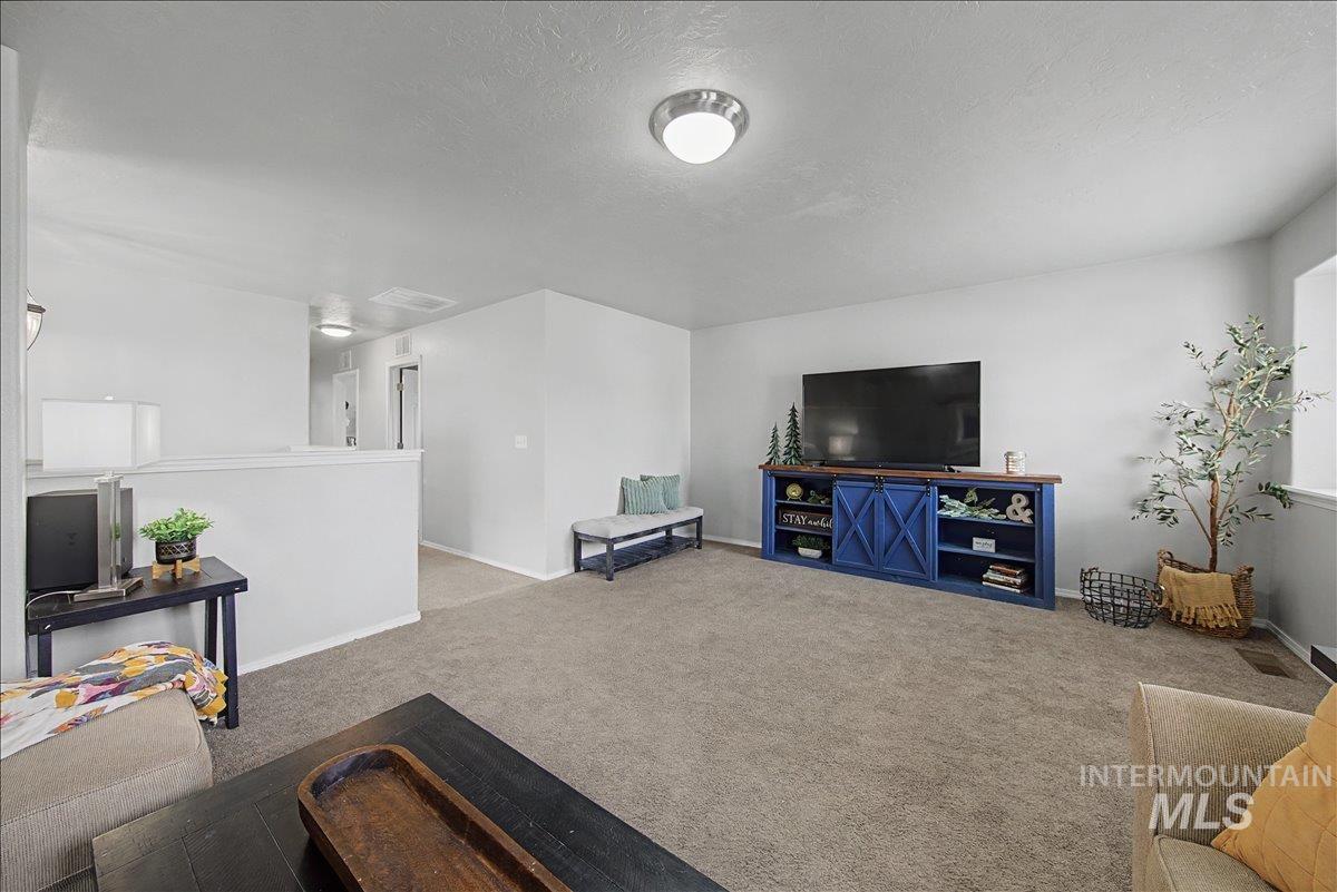681 West Archerfield Street Meridian, ID 83646 - Photo 30 of 43 Living room featuring carpet flooring and a textured ceiling