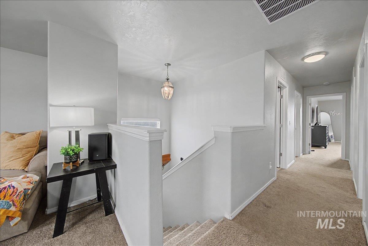 681 West Archerfield Street Meridian, ID 83646 - Photo 32 of 43 Hall featuring an upstairs landing and light colored carpet