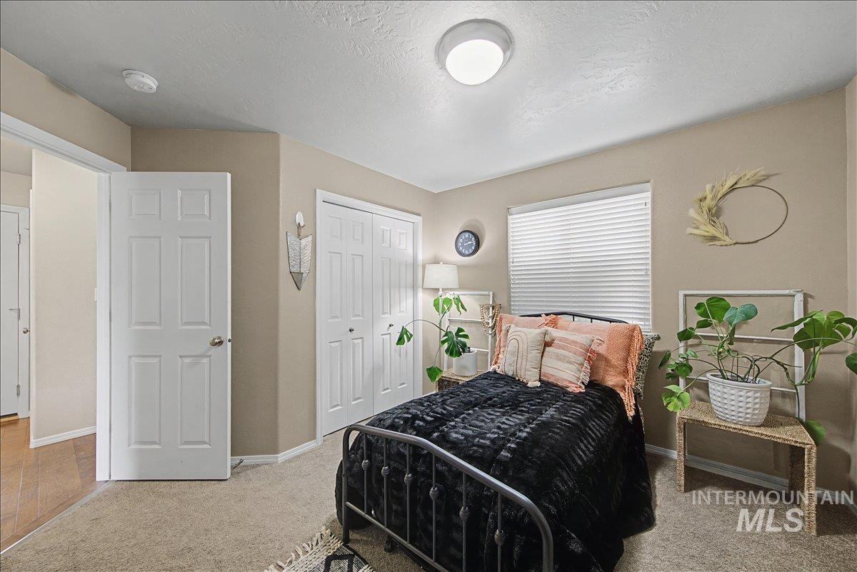681 West Archerfield Street Meridian, ID 83646 - Photo 34 of 43 Bedroom featuring a closet, light carpet, and a textured ceiling