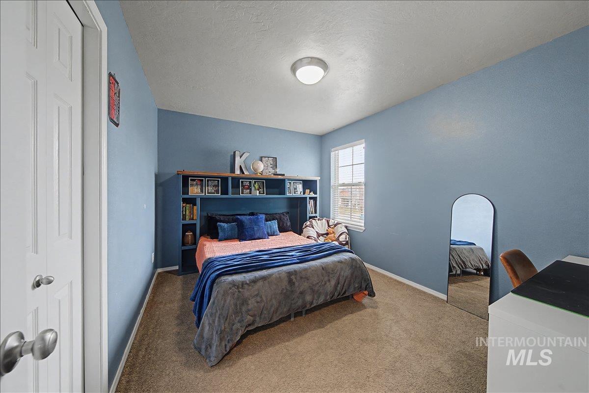 681 West Archerfield Street Meridian, ID 83646 - Photo 36 of 43 Carpeted bedroom featuring a closet and a textured ceiling