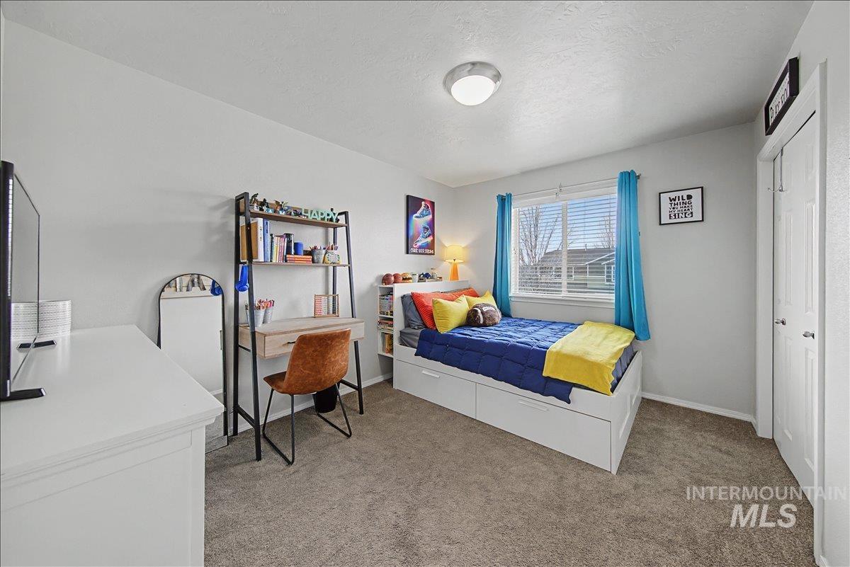 681 West Archerfield Street Meridian, ID 83646 - Photo 39 of 43 Bedroom with light carpet, a closet, and a textured ceiling