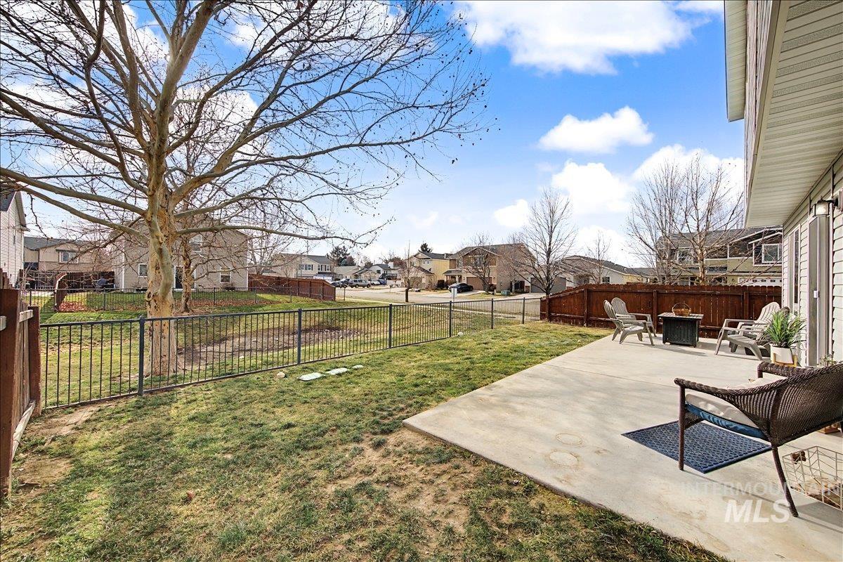 681 West Archerfield Street Meridian, ID 83646 - Photo 43 of 43 Fenced backyard featuring a residential view, a patio, and a fire pit