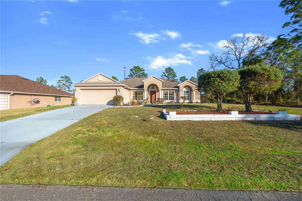 27 Vinca Street Homosassa, FL 34446 - Photo 11 of 50 a view of a house with a yard