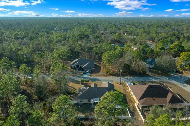 an aerial view of residential houses with outdoor space and street view