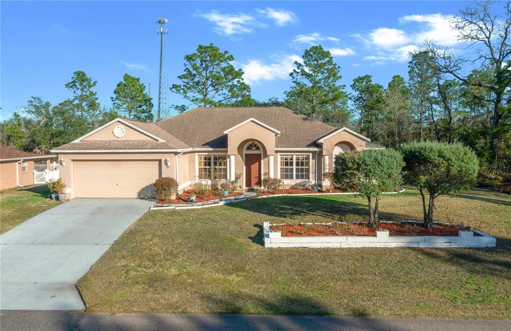 27 Vinca Street Homosassa, FL 34446 - Photo 17 of 50 a front view of a house with a yard
