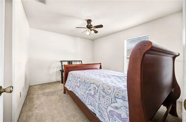 a bedroom with bed and wooden floor