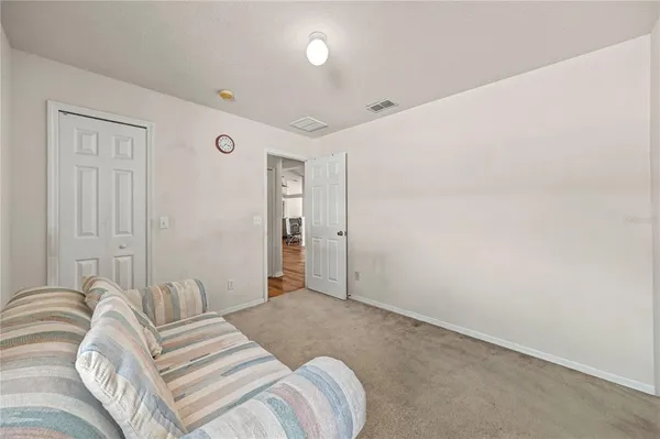 a bedroom with a bed and a night stand