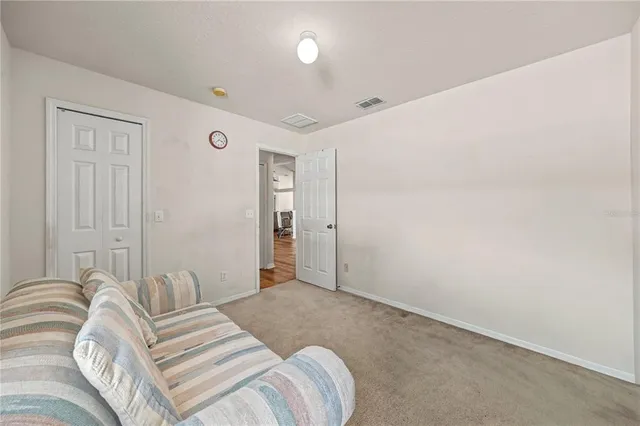 a bedroom with a bed and a night stand