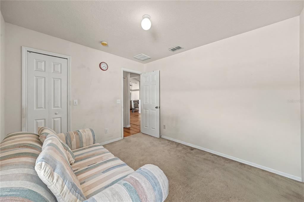 27 Vinca Street Homosassa, FL 34446 - Photo 23 of 50 a bedroom with a bed and a night stand