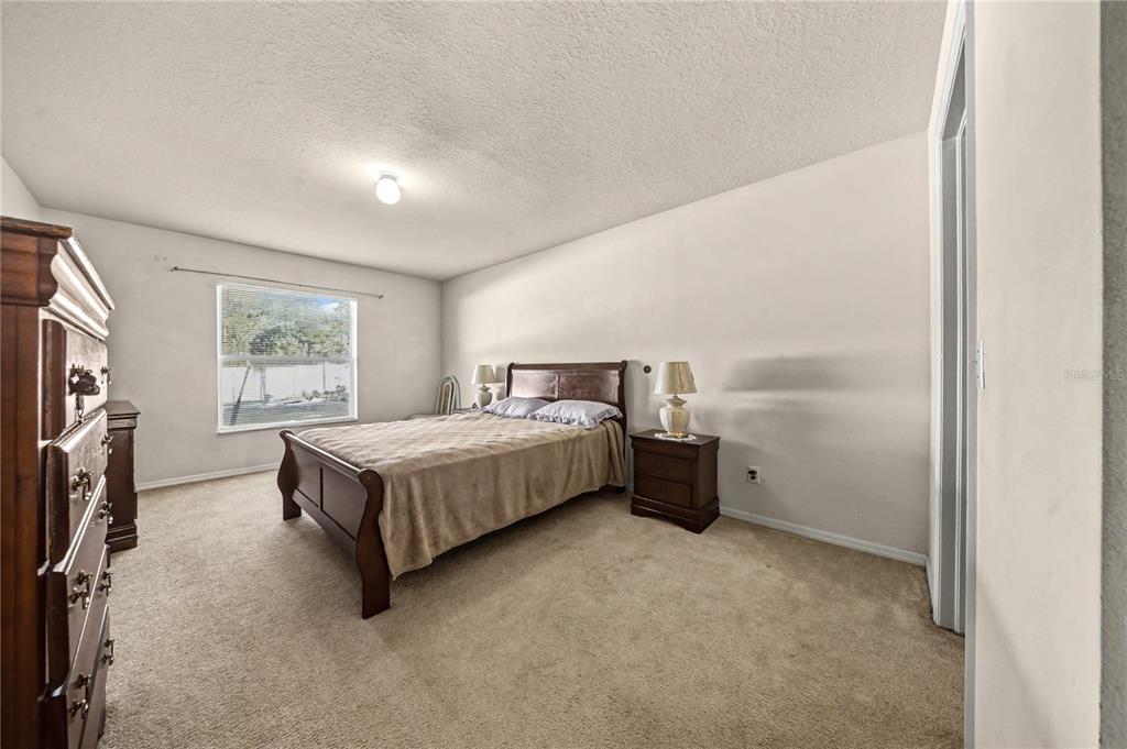 27 Vinca Street Homosassa, FL 34446 - Photo 26 of 50 a bed sitting in a spacious bedroom next to a window
