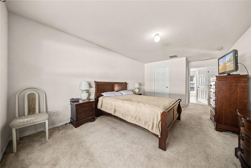 27 Vinca Street Homosassa, FL 34446 - Photo 27 of 50 a bedroom with a bed chair and mirror