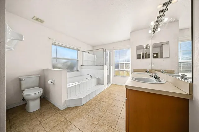 a spacious bathroom with a sink toilet and shower