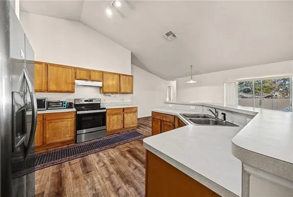 a kitchen with stainless steel appliances granite countertop a stove and a sink