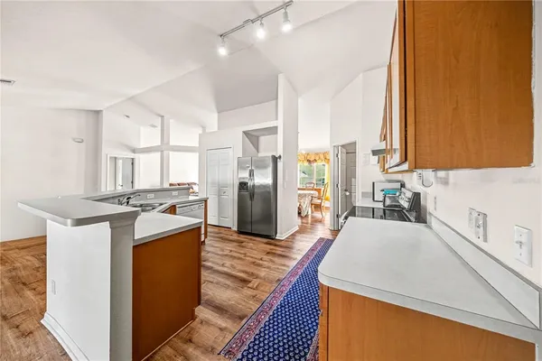 a kitchen with stainless steel appliances granite countertop a refrigerator and a sink