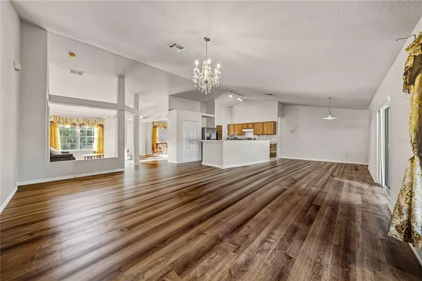 a view of a hallway view with wooden floor and staircase