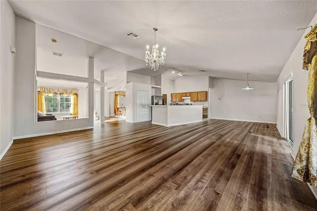 a view of a hallway view with wooden floor and staircase