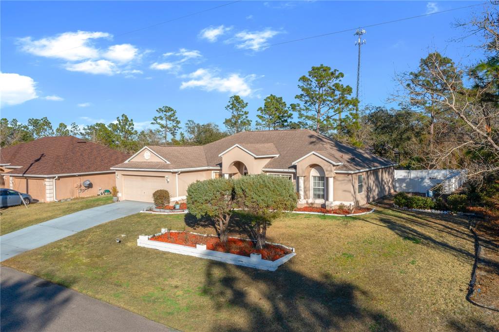 27 Vinca Street Homosassa, FL 34446 - Photo 4 of 50 a front view of a house with a yard