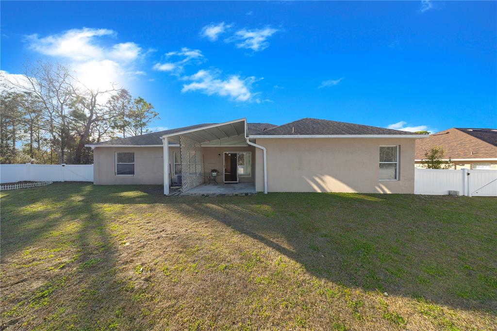 27 Vinca Street Homosassa, FL 34446 - Photo 7 of 50 a view of a house with a yard and garage