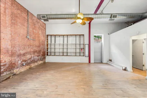 a view of a room with a ceiling fan and window