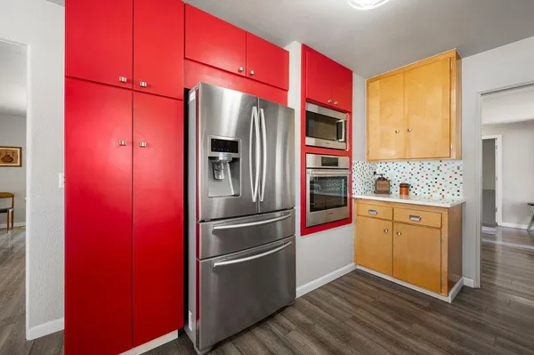 a kitchen with granite countertop stainless steel appliances and wooden cabinets