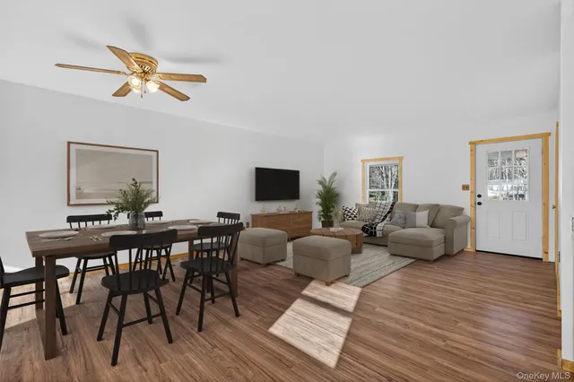 a view of a kitchen with wooden floor and electronic appliances