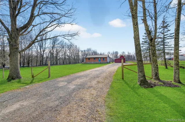 a view of a house with a backyard and a yard