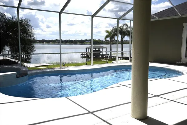 a view of swimming pool with a lounge chair