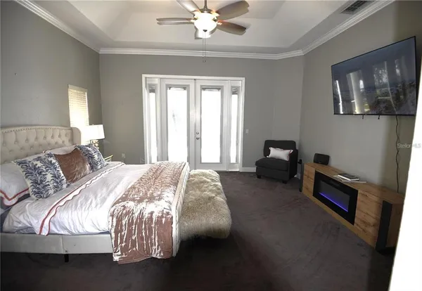 a bedroom with a bed and a chandelier