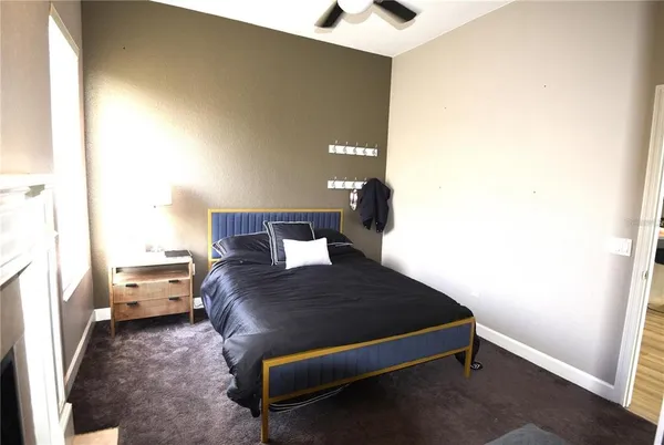 a bedroom with a bed and lamp