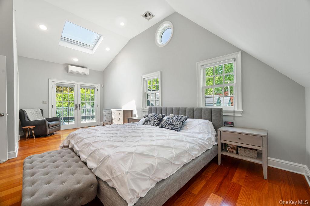 22 Crane Road Scarsdale, NY 10583 - Photo 12 of 32 Primary bedroom suite with French doors to balcony overlooking beautiful yard replete with specimen plantings.