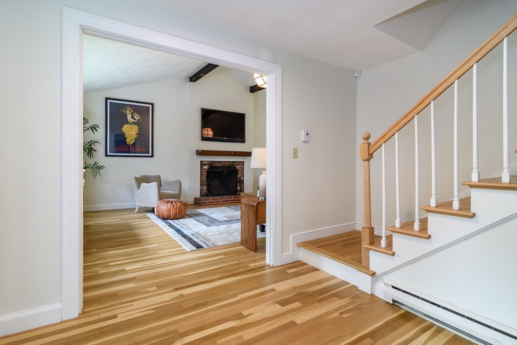 124 Everett Street Natick, MA 01760 - Photo 5 of 36 a view of a livingroom with wooden floor and staircase