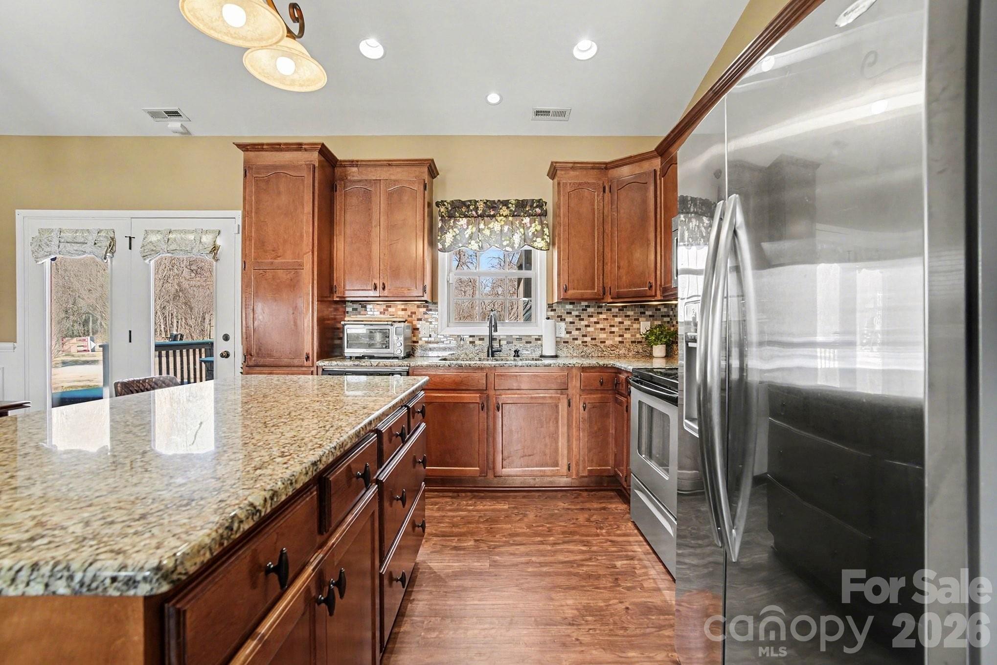 311 Massey Deal Road Statesville, NC 28625 - Photo 13 of 34 a large kitchen with kitchen island granite countertop a large counter top and stainless steel appliances