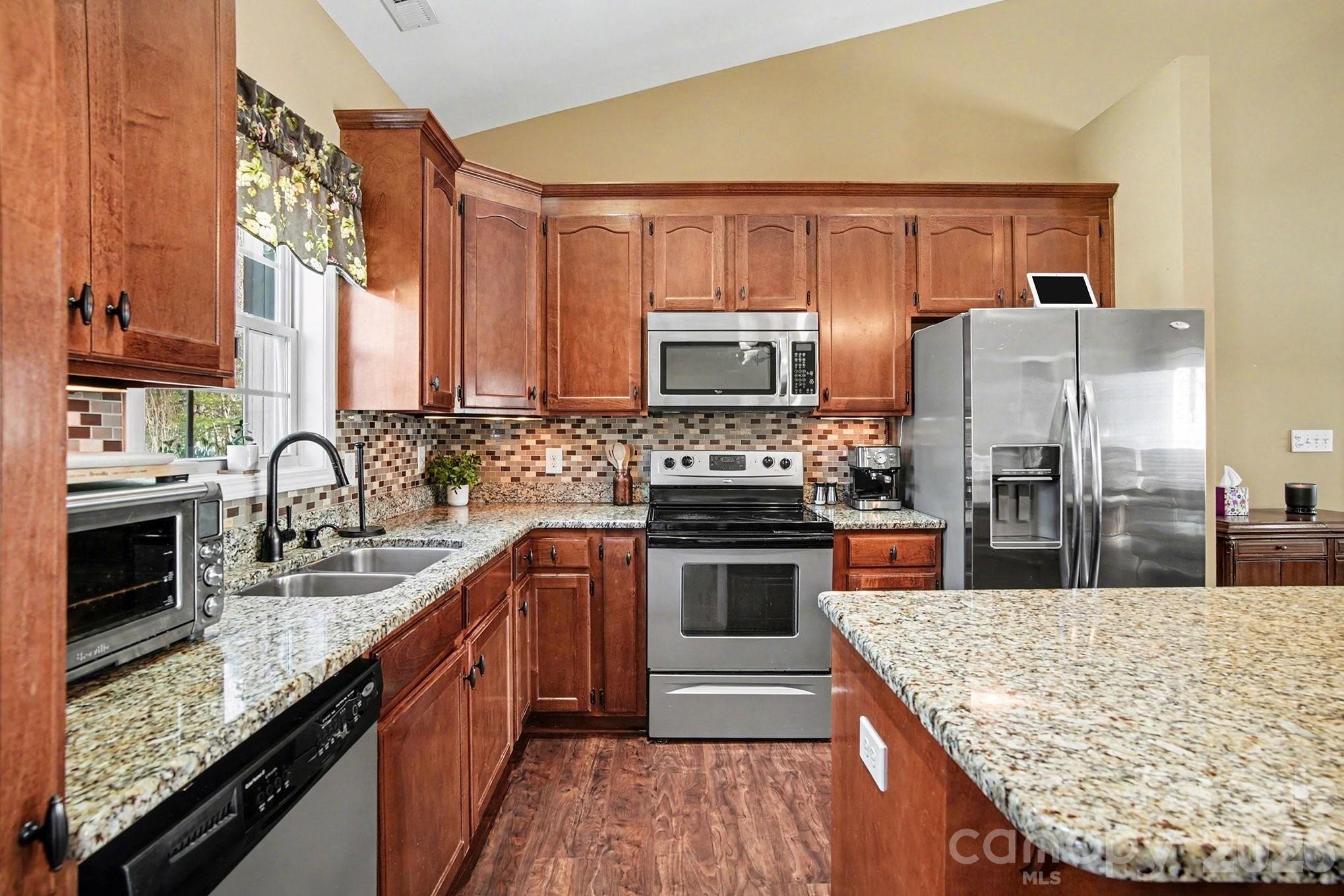 311 Massey Deal Road Statesville, NC 28625 - Photo 14 of 34 a kitchen with stainless steel appliances granite countertop a sink stove microwave and refrigerator